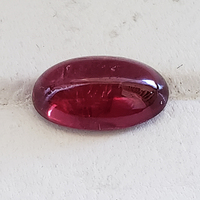 Natural unique untreated African ruby cabochon.  This well cut oval unheated ruby cab is from the Umba River region of Tanzania.  Nice lively rich red with ruby port undertones.