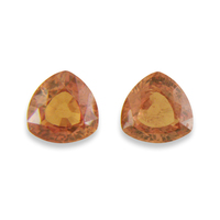 Pair of trillion shape unheated orange sapphires from the Umba River Valley in Africa. These lively sapphire trillions are very bright with golden apricot tones.