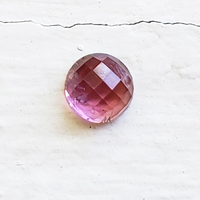 This 7.5 mm round rose cut pink tourmaline is a pretty rose pink color, clean and well cut.