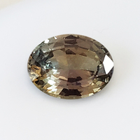 Natural untreated oval sapphire with slight color change from champagne gray to  verbena green.   This brilliant Tanzanian sapphire is from the Umba River region of Africa. The color of this well cut unheated sapphire is very unique yet very typical of th