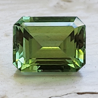 Classic emerald-cut green tourmaline.  This untreated green tourmaline is a nice bright leaf green color pantone color pepper stem.  This unheated rectangle tourmaline is well cut and lively.