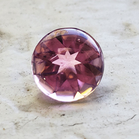 Rose color pink buff-top tourmaline.  This round pink tourmaline from Mozambique is untreated and has a low dome cabochon top and faceted bottom.  