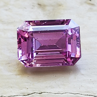 Emerald-cut lavender purple pink sapphire. This natural well cut lavender sapphire has flashes of pink and very lively.
