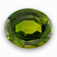Large oval green tourmaline.  This untreated green tourmaline is a nice bright olive green color with flashes gold and lime green.  This unheated oval tourmaline is well cut and lively.