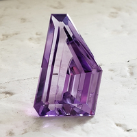 Lively purple amethyst custom cut in a fancy shape.  This amethyst has excellent clarity and is cut beautifully in a unique shape to be set either vertical or horizontal. 