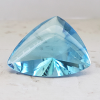 Very large fancy cut buff top sky blue topaz.  Lively custom cut in a fancy triangular shape. This blue topaz has excellent clarity and is cut beautifully with the cabochon top and faceted bottom.