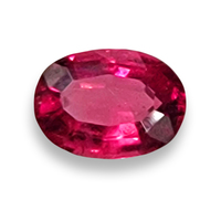 Bright Oval Rubellite tourmaline with flashes of pink and purple.