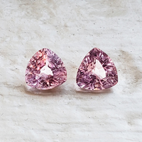 Pair of 5 mm trillion baby pink sapphires. This lovely pair of pastel pink sapphires have a good triangle shape, clean and very lively.  This 5 millimeter pair would be perfect as pink sapphire side stones.